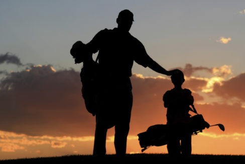Father And Son Golfers In The Sunset